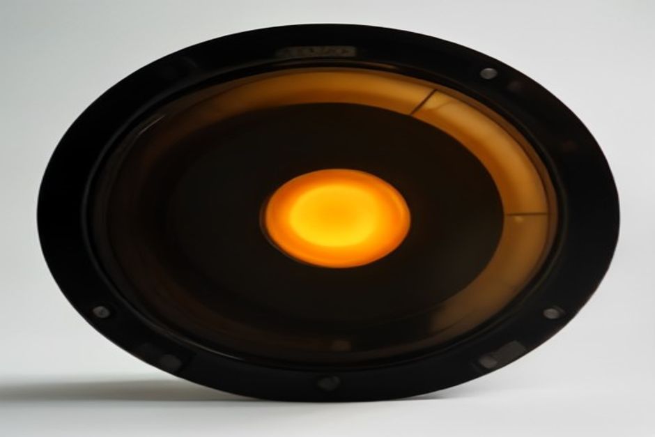 A single glowing film cell with a stereo waveform baked into its sprocket holes, sitting on an open workbench, warm amber studio light, an unlocked padlock beside it